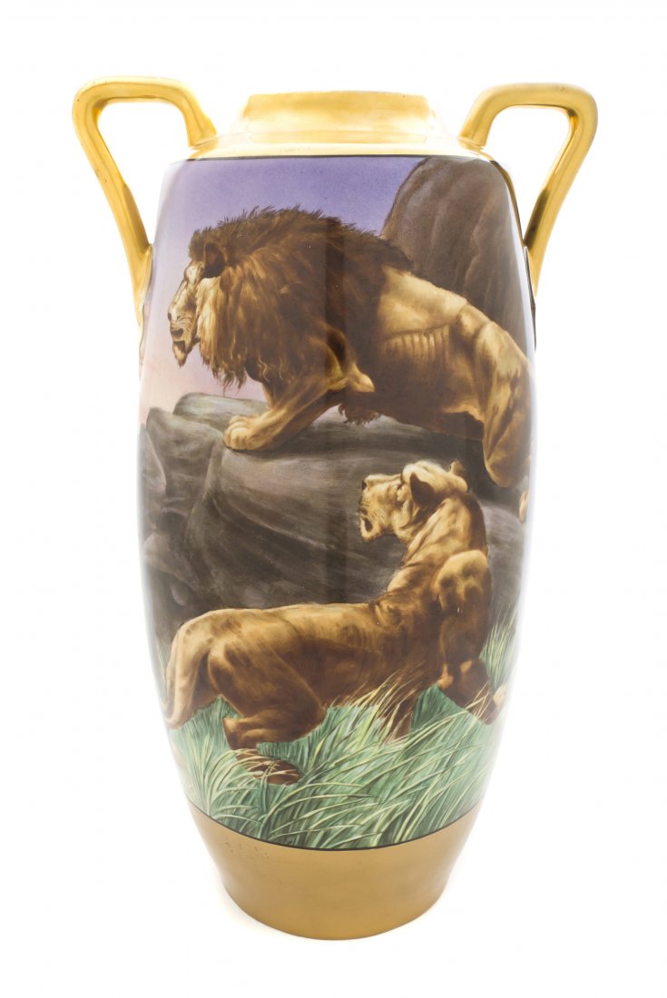 A Continental Porcelain Vase, Height over handles : A Continental Porcelain Vase, of square handled baluster form, depicting lions in a rocky landscape, signed Osborne. Height over handles 20 1/8 inches.