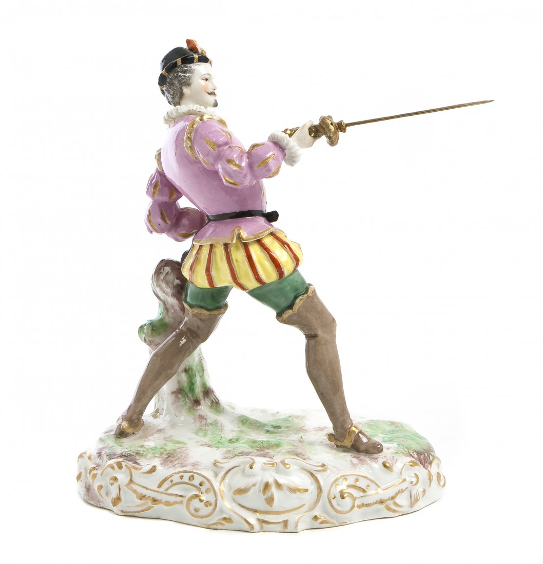 A Meissen Porcelain Figure, Height 9 inches.: A Meissen Porcelain Figure, depicting a fencing gentleman, having crossed swords in underglaze blue. Height 9 inches. Property from the Collection of Mr. and Mrs. Allen M. Taylor, Milwaukee, Wisconsin