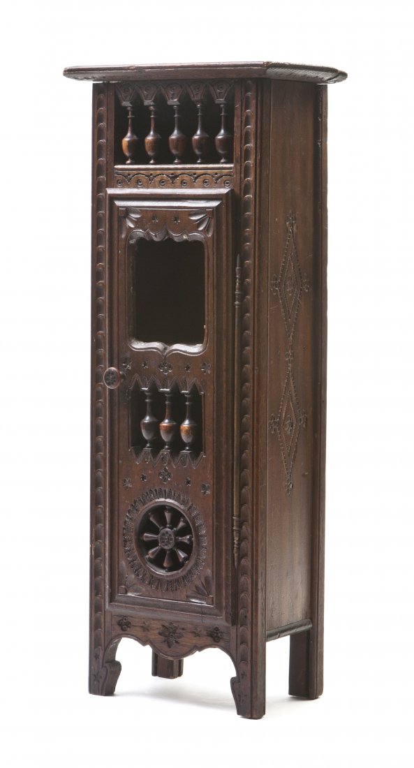 A Continental Diminutive Walnut Watch Stand, Heigh: A Continental Diminutive Walnut Watch Stand, having a rectangular top over an alabaster spindled cornice and glass plate, with repeating baluster decoration raised on four feet. Height 17 3/4 inches.