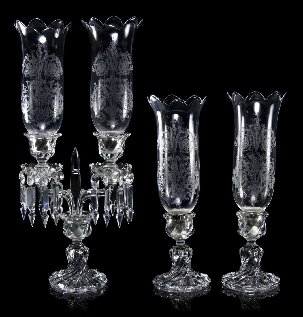 A Set of Baccarat Glass Lighting, Height of taller: A Set of Baccarat Glass Lighting, comprising a pair of two-light candelabra and a pair of candlesticks, each with an etched glass shade. Height of taller pair 22 3/4 inches.