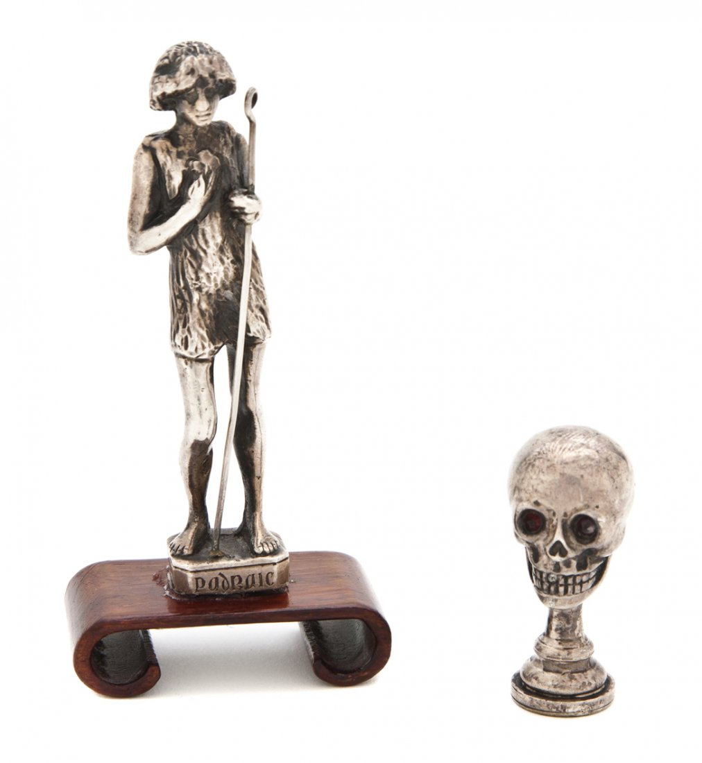 An Irish Silver Figural Seal, Edmund Johnson, Heig: An Irish Silver Figural Seal, Edmund Johnson, 1902, depicting Padraic standing with a cane, together with an American sterling silver skull form seal; approximate total weighable 2.31 ozt. Height of f
