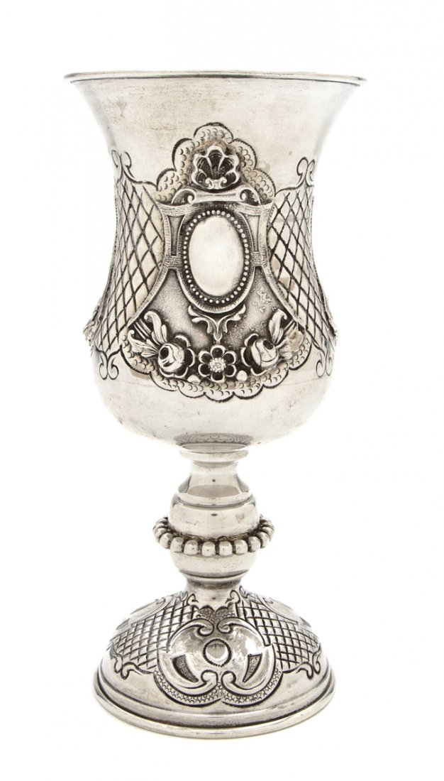 A Continental Silver Chalice, Height 7 1/8 inches.: A Continental Silver Chalice, of baluster form with repousse shell, lattice and floral swag decoration, stamped 833; approximate weight 5.33 ozt. Height 7 1/8 inches. Property from the Estate of Babet