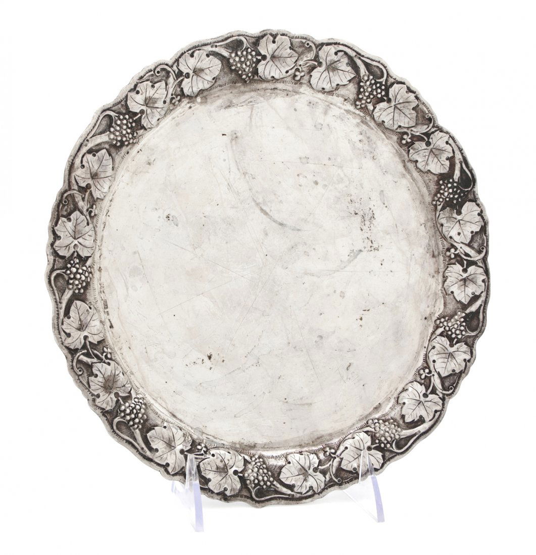 A Continental Silver Plate, Diameter 9 5/8 inches.: A Continental Silver Plate, of circular form having a grapevine border; approximate weight 13.22 ozt. Diameter 9 5/8 inches. Property from the Estate of Helen and C. Nicholas Johnson, Jr., Cave Creek,