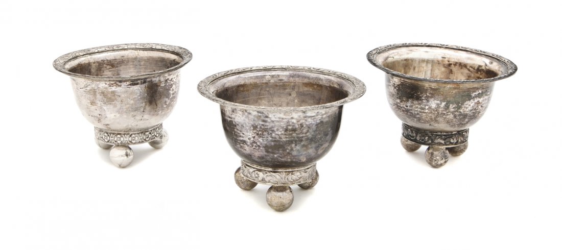 A Set of Three Russian Silver Salt Cellars, Height: A Set of Three Russian Silver Salt Cellars, each of circular form with a flared foliate decorated rim, raised on three spherical feet, bearing the Odessa town mark, assayer's marks for Vasily Lapshin 