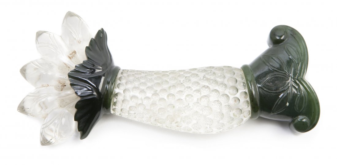 A Rock Crystal and Nephrite Dagger Hilt, Length 5: A Rock Crystal and Nephrite Dagger Hilt, of curved form with stylized foliate decoration, the handle with a textured finish. Length 5 3/4 inches.
