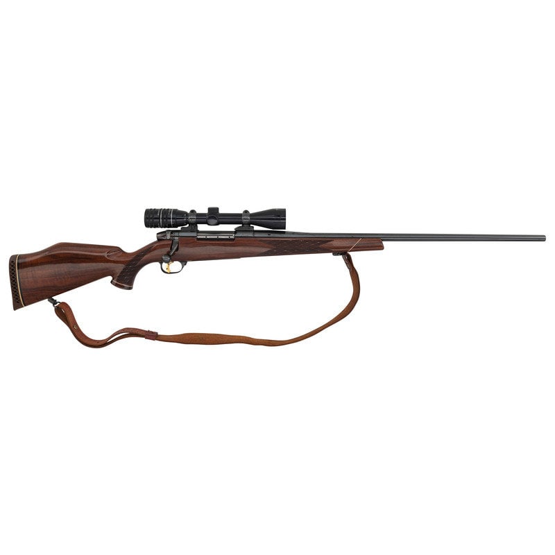 ** Weatherby Mark V Deluxe with Weatherby Scope: ** Weatherby Mark V Deluxe with Weatherby Scope .300 WBY Mag. 26" barrel length. SN: P47045. Blued metal finish with Parkerized finish to top of receiver. AA Claro walnut stock has skip-line