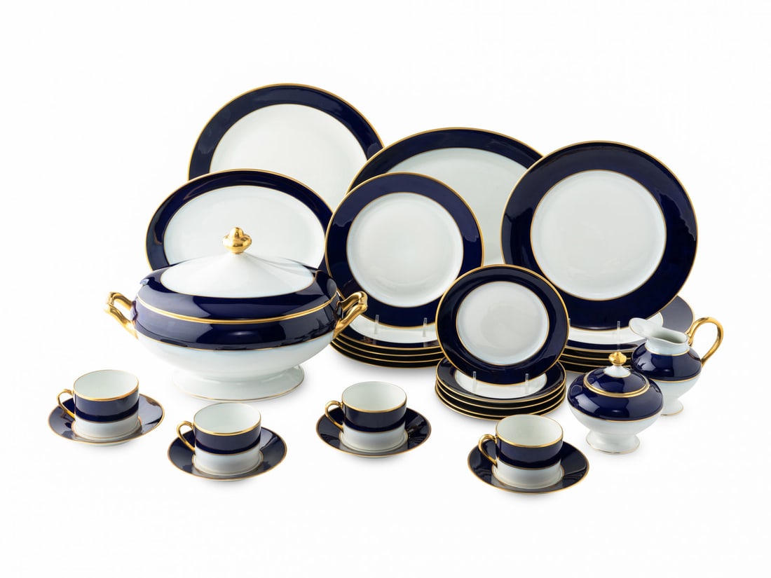 A Bernardaud Limoges Porcelain Dinner Service: A Bernardaud Limoges Porcelain Dinner Service with cobalt blue border decoration and gilt trim, comprising: 12 dinner plates 24 salad plates 12 bread and butter plates 12 soup bowls 12 coffee cups 13