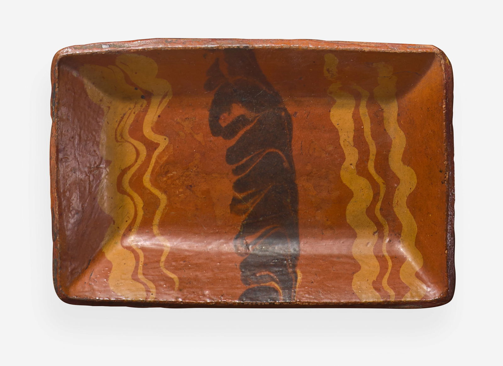 A glazed and slip-decorated rectangular redware bread plate, Pennsylvania, 19th century (1 of 1)