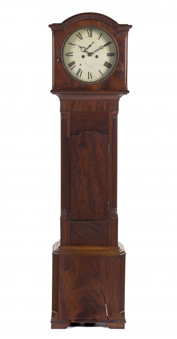 An American Mahogany and Walnut Tall Case Clock, H: An American Mahogany and Walnut Tall Case Clock, having an arched crest over the circular dial with Roman numerals and subsidiary second dial with Arabic numerals above the case with a single door fla