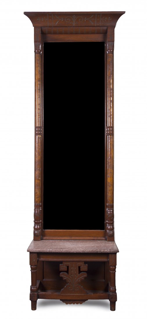 A Victorian Walnut Pier Mirror, Height 86 3/4 inch: A Victorian Walnut Pier Mirror, having a flared cornice over the vertical rectangular plate flanked by columnar supports, set on a rectangular marble base, raised on turned legs joined by stretchers. 