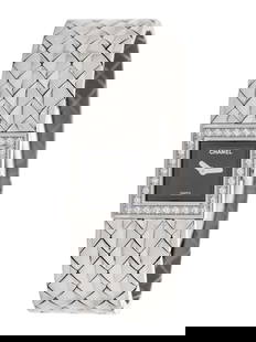 CHANEL, STAINLESS STEEL AND DIAMOND 'MATELASSÉ' WATCH: CHANEL, STAINLESS STEEL AND DIAMOND 'MATELASSÉ' WATCH 19.00 x 19.00 mm case, diamond bezel, quilted black dial, quartz movement, integrated quilted link stainless steel bracelet with deployant cl