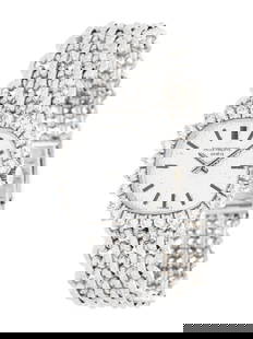 PATEK PHILIPPE, WHITE GOLD AND DIAMOND WATCH: PATEK PHILIPPE, WHITE GOLD AND DIAMOND WATCH 25.00 x 22.00 mm case, diamond bezel, textured silvered dial, manual wind movement, textured mesh link bracelet with foldover clasp. 6 inches long. Case ba