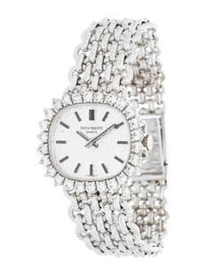 PATEK PHILIPPE, WHITE GOLD AND DIAMOND WATCH: PATEK PHILIPPE, WHITE GOLD AND DIAMOND WATCH 25.00 x 22.00 mm case, diamond bezel, textured silvered dial, manual wind movement, textured mesh link bracelet with foldover clasp. 6 inches long. Case ba