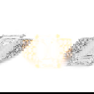 AN IMPORTANT DIAMOND RING: AN IMPORTANT DIAMOND RING Containing one emerald cut diamond weighing 10.05 carats and 46 round brilliant cut diamonds weighing approximately 1.60 carats total. Mounted in yellow gold. Ring size 5 1/4
