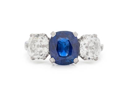 ANTIQUE, BRITISH, SAPPHIRE AND DIAMOND RING: ANTIQUE, BRITISH, SAPPHIRE AND DIAMOND RING Containing one cushion cut sapphire measuring approximately 8.00 x 7.00 x 4.65 mm and two old mine cut diamonds weighing approximately 1.75 carats total. Mo