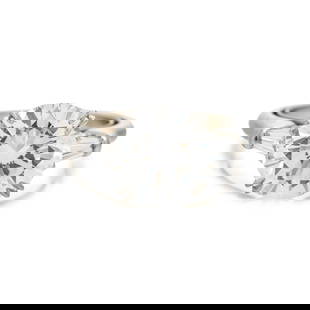 HARRY WINSTON, DIAMOND RING: HARRY WINSTON, DIAMOND RING Containing one round brilliant cut diamond weighing 4.12 carats and two tapered baguette diamonds weighing approximately 0.40 carat total. Mounted in platinum. Ring size 5