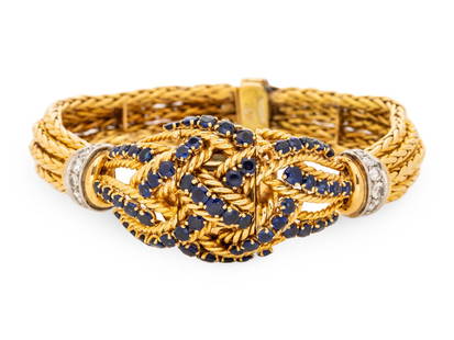 GÜBELIN, YELLOW GOLD, SAPPHIRE AND DIAMOND SURPRISE WATCH: GÜBELIN, YELLOW GOLD, SAPPHIRE AND DIAMOND SURPRISE WATCH The hinged cover and lugs containing round mixed cut sapphires, round brilliant and single cut diamonds, silvered dial signed Gübeli