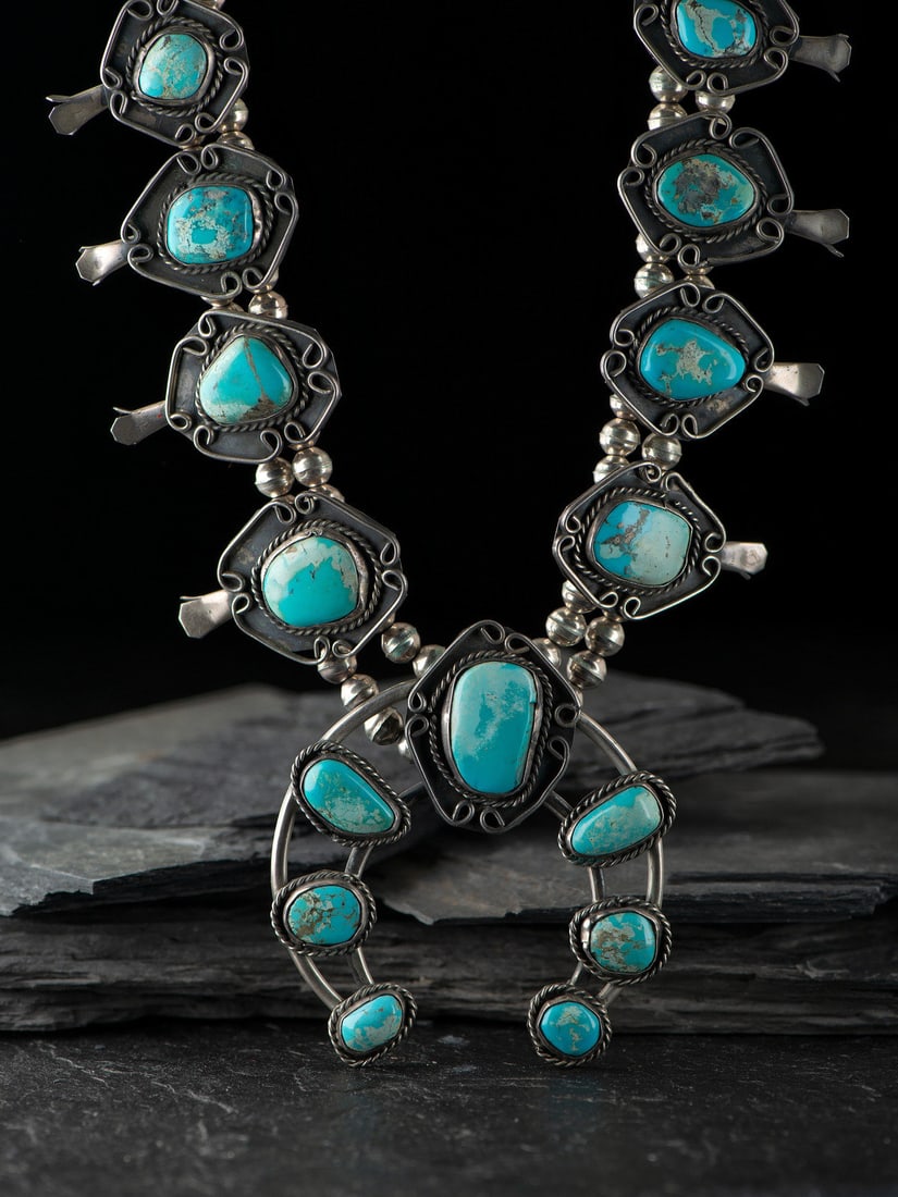 Navajo Silver and Turquoise Squash Blossom Necklace: Navajo Silver and Turquoise Squash Blossom Necklace third quarter 20th century not marked drop length 15 inches, naja length 3-1/2 inches x width 3-1/4 inches, weight 143.6 dwt. This lot is located in