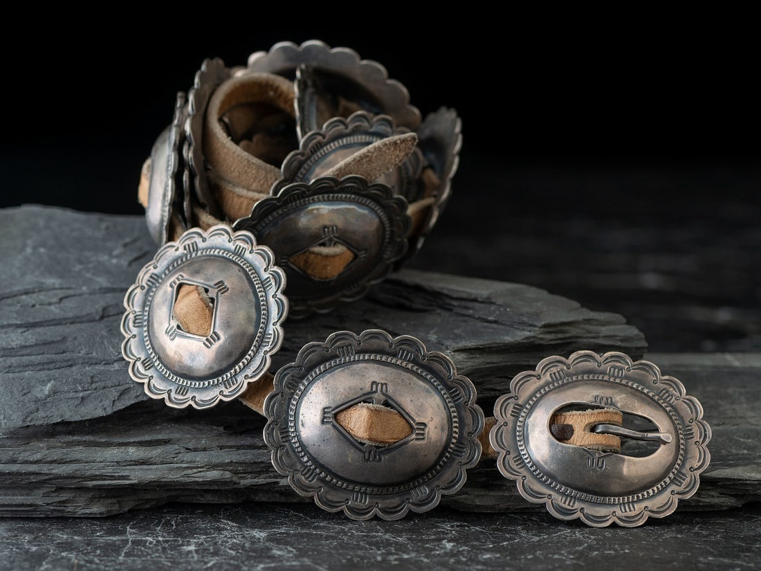 Navajo Silver Concha Belt: Navajo Silver Concha Belt third quarter 20th century twelve conchas and matching buckle; not marked belt length 49 inches x width 1/2 inch, concha / buckle length 2-1/2 inches x width 2-1/4 inches, to