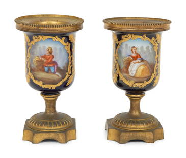 A Pair of Small Sevrés Style Porcelain and Gilt Bronze Urns: A Pair of Small Sevrés Style Porcelain and Gilt Bronze Urns Mid 19th Century Height 5 1/2 x diameter 3 inches. Property from a Private Collection, Stuart, Florida