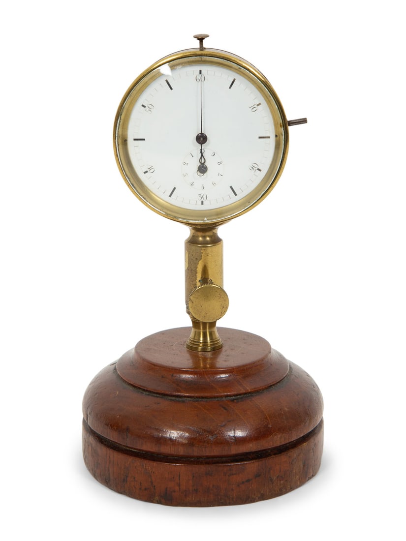 A French Brass Stopwatch on Stand: A French Brass Stopwatch on Stand Circa 1900 with circular seconds dial and inset subsidiary minutes dial, with short telescoping mechanism, on a circular mahogany base. Height 6 1/2 inches. This lot 