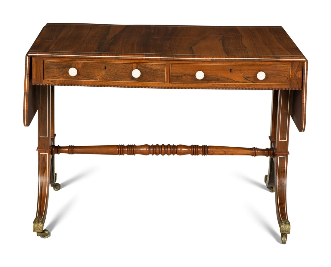 A Regency Style Rosewood Bone-Inlaid Sofa Table: A Regency Style Rosewood Bone-Inlaid Sofa Table Late 19th/Early 20th Century inlaid with fleurs-de-lys at the corners. Closed, height 28 1/8 x width 40 x depth including knobs 28 inches; open, width 6