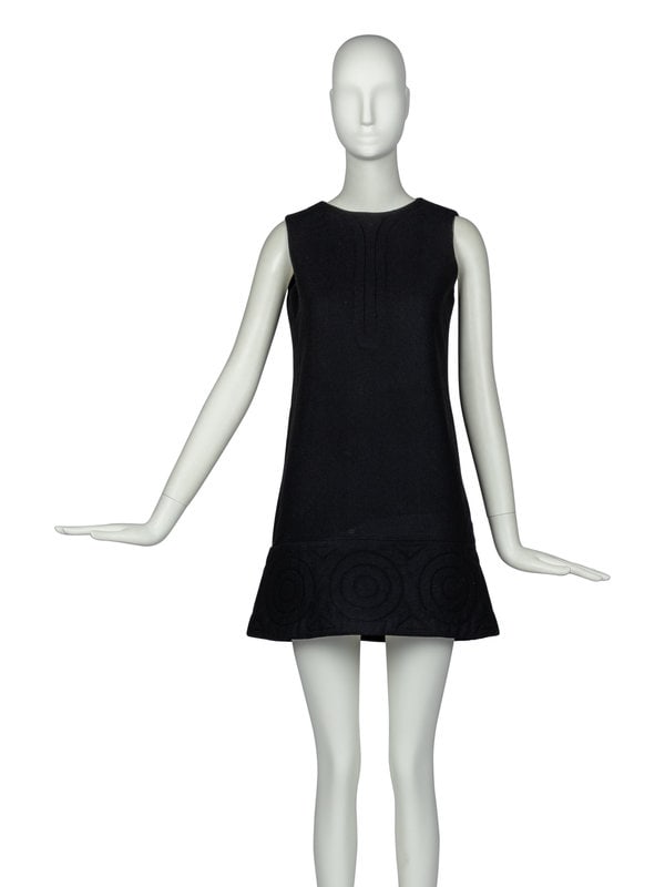 Pierre Cardin Dress with Embroidered Hem, 1960s: Pierre Cardin Dress with Embroidered Hem, 1960s Sleeveless, a-line day dress in black wool crepe with a padded, bottom hemline with geometric embroidery details. Jacket features a rear zipper closure 