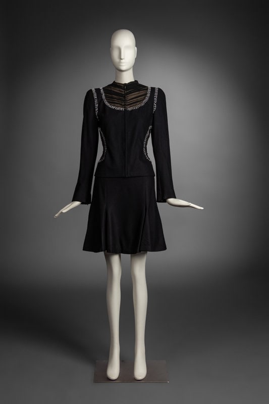 Alexander McQueen Ensemble, 2004: Alexander McQueen Ensemble, 2004 THE FIRSTCollarless, zip-front jacket in black wool-silk weave with semi-sheer chiffon panel and decorative contrast stitch overlays. Fully-lined in nude, silk ch