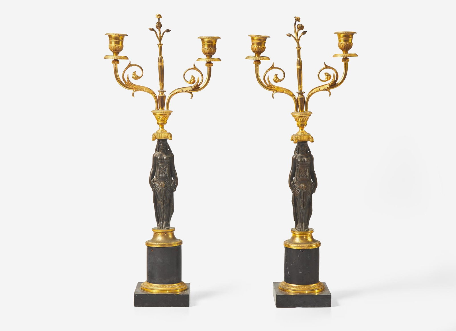 A pair of French Empire gilt and patinated bronze candelabras, first quarter 19th century   Of (1 of 3)