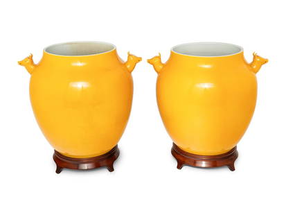 A Pair of Chinese Yellow Glazed Porcelain 'Deer' Jars: A Pair of Chinese Yellow Glazed Porcelain 'Deer' Jars 20th Century each with a wood stand. Height of porcelain 14 x width over handles 15 x depth 14 inches.