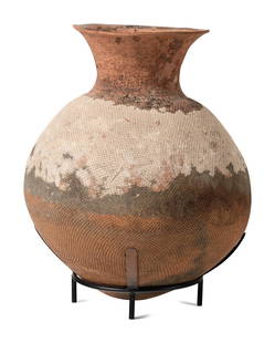 A Large African Earthenware Vessel: A Large African Earthenware Vessel on a custom metal stand. Height of vessel 24 x diameter 22 inches. Provenance: Douglas Dawson Gallery, Chicago