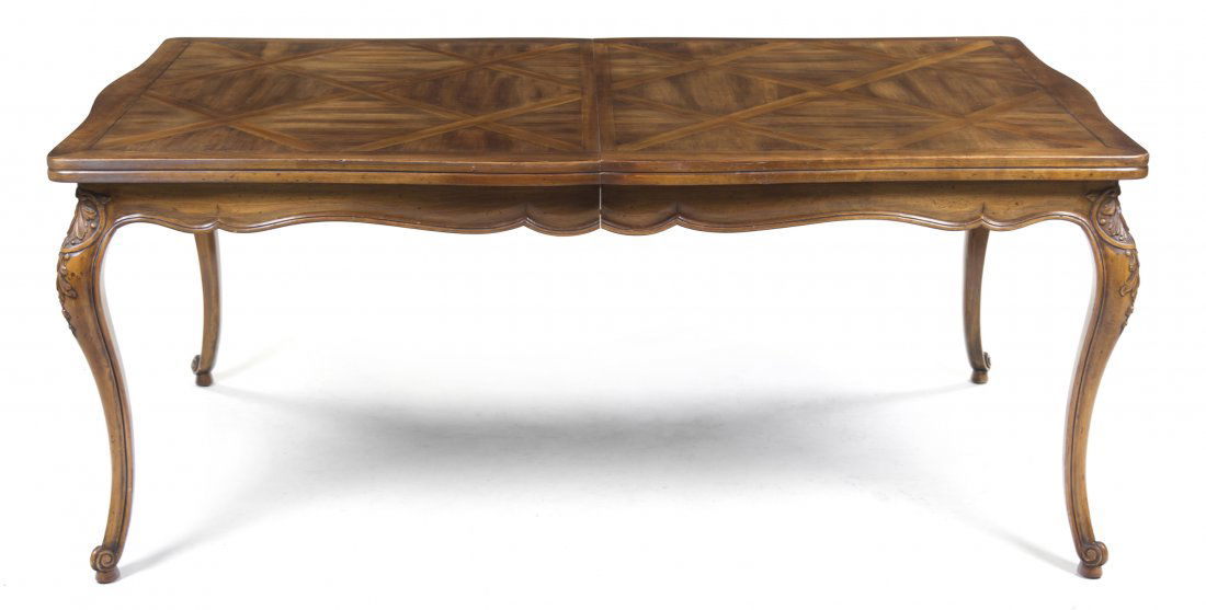 A French Provincial Style Parquetry Table, Widdic: A French Provincial Style Parquetry Table, Widdicomb, having a shaped rectangular top, raised on carved cabriole legs with two leaves. Height 29 1/2 x width 104 x depth 46 inches. Property from the Es