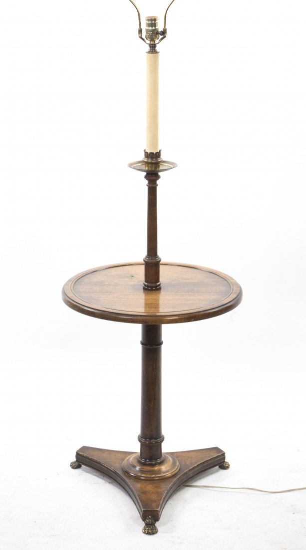 A Continental Wood Floor Lamp, Height 58 inches.: A Continental Wood Floor Lamp, having a circular medial shelf and a columnar support on a tripartite base. Height 58 inches. Property from the Estate of Helen and C. Nicholas Johnson, Jr., Cave Creek,