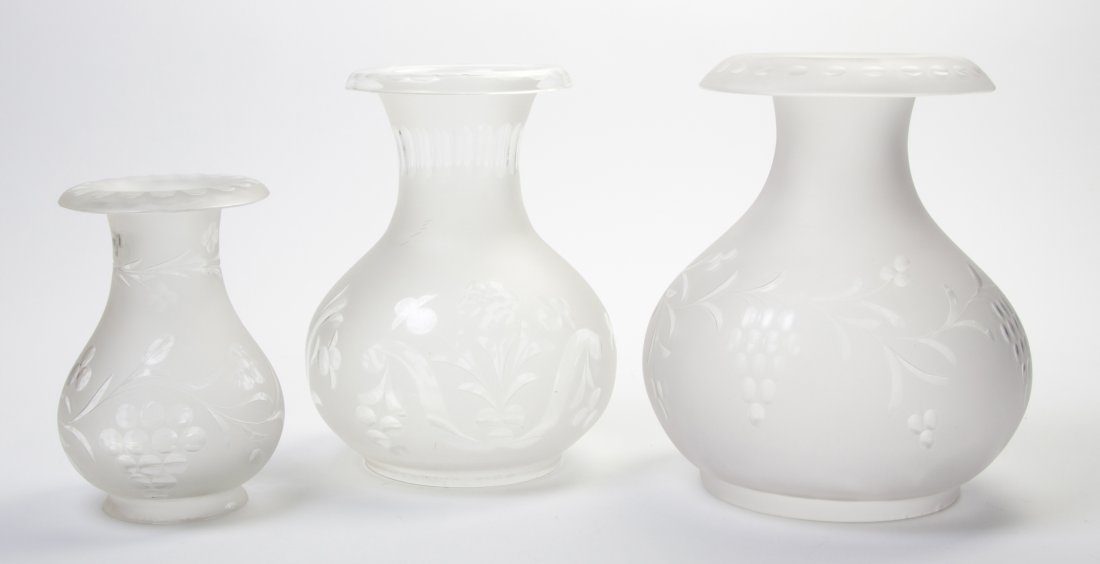 Three Frosted and Etched Glass Hurricane Shades, : Three Frosted and Etched Glass Hurricane Shades, of varying sizes, two with grapevine decoration, the other with foliate decoration. Height of tallest 10 inches. Property from the Estate of William P.