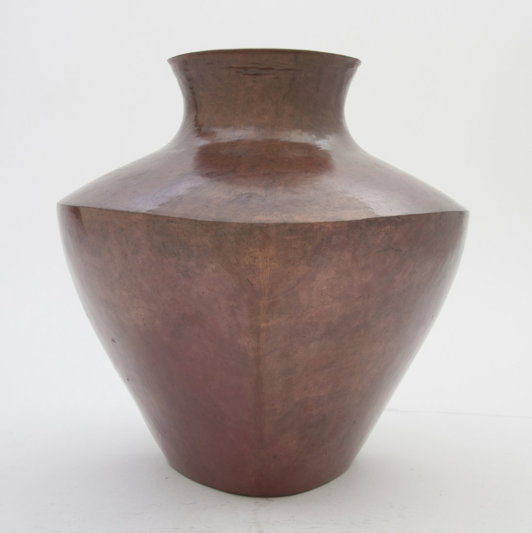 A Mexican Copper Vase, Abdon Punzo Angel, Height: A Mexican Copper Vase, Abdon Punzo Angel, of asymmetrical flattened baluster form, with a flared rim. Height 9 1/4 inches.