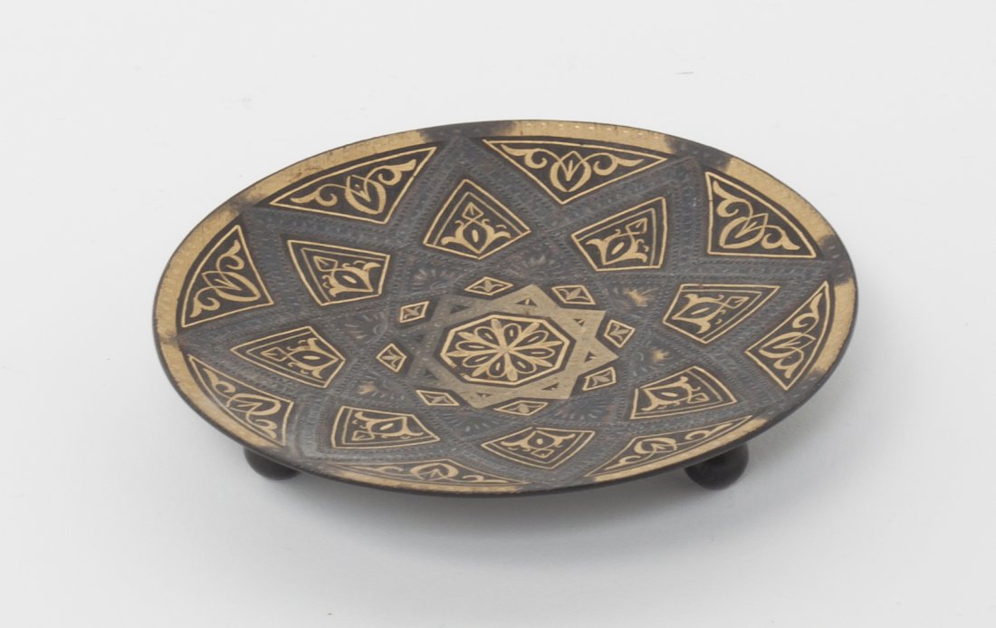 A Middle Eastern Saucer, Diameter 3 inches.: A Middle Eastern Saucer, having a gilt and black star design. Diameter 3 inches.