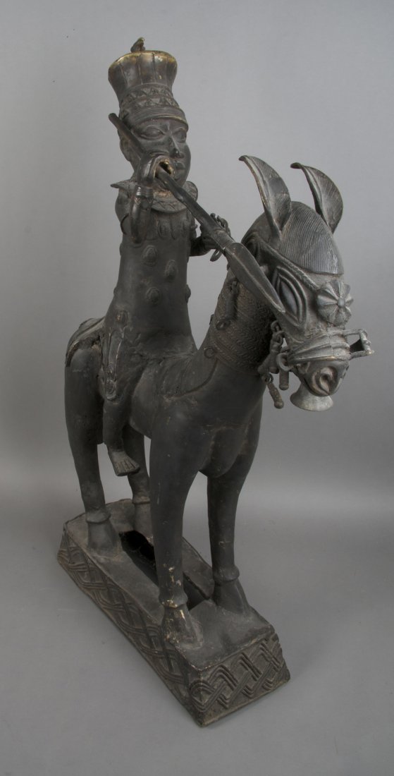 A Cast Bronze Equestrian Figure, Benin, Height 35: A Cast Bronze Equestrian Figure, Benin, depicting an Oba wearing crown and holding a spear on horseback. Height 35 inches.