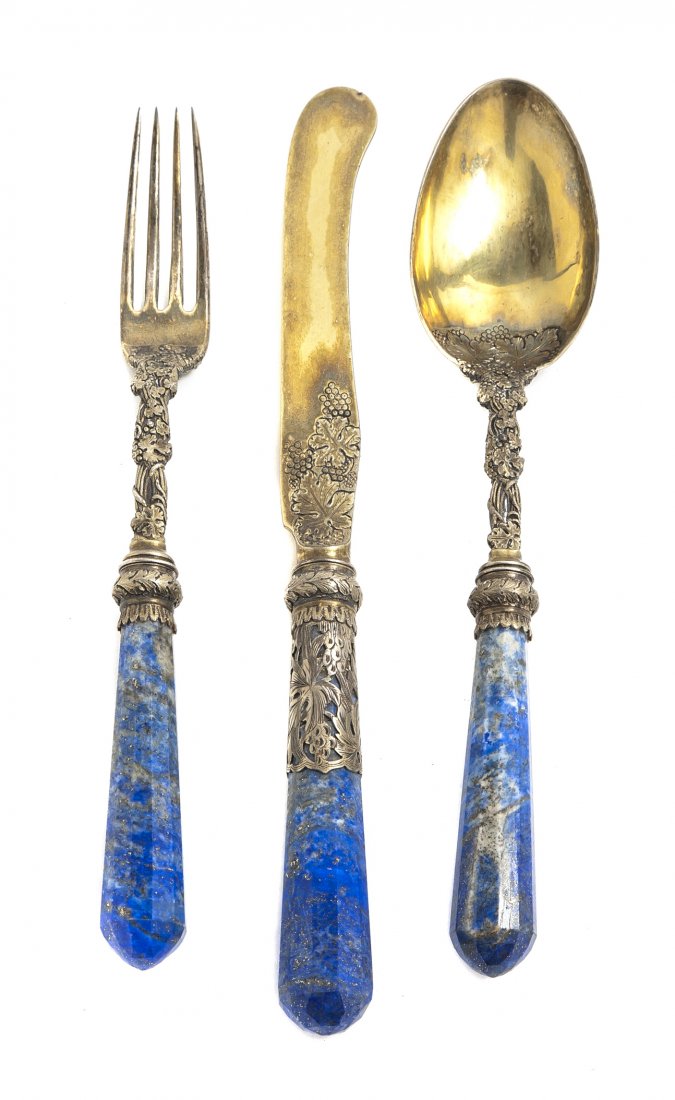 An English Gilt Silver and Lapis Single Place Set: An English Gilt Silver and Lapis Single Place Setting, Charles Rawlings, London, 1825, each cast with grapevine decoration, having faceted lapis handles, set in a fitted case. Length of knife 9 1/4 in