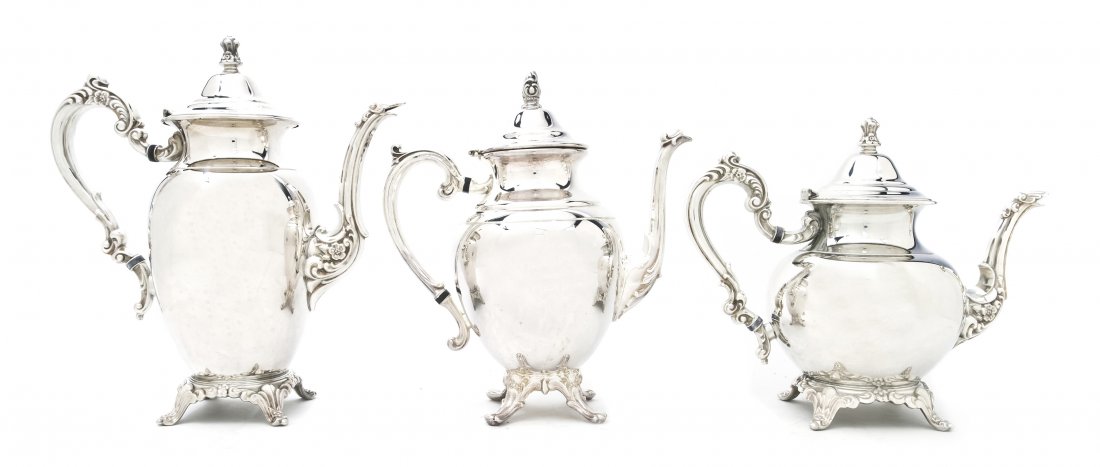 An American Silverplate Tea and Coffee Service, W: An American Silverplate Tea and Coffee Service, William Rogers, comprising a hot water pot, a teapot and a coffee pot. Height of tallest 11 inches.