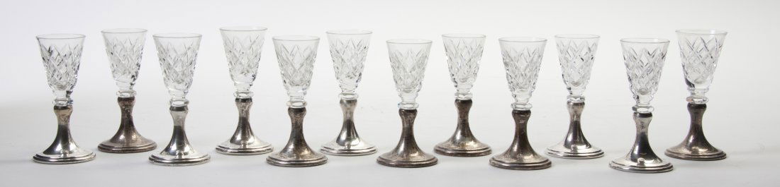A Set of Twelve American Sterling Silver Mounted: A Set of Twelve American Sterling Silver Mounted Cut Glass Cordials, each raised on a circular foot, weighted. Height of tallest 14 inches. Property from the Estate of Helen and C. Nicholas Johnson, J