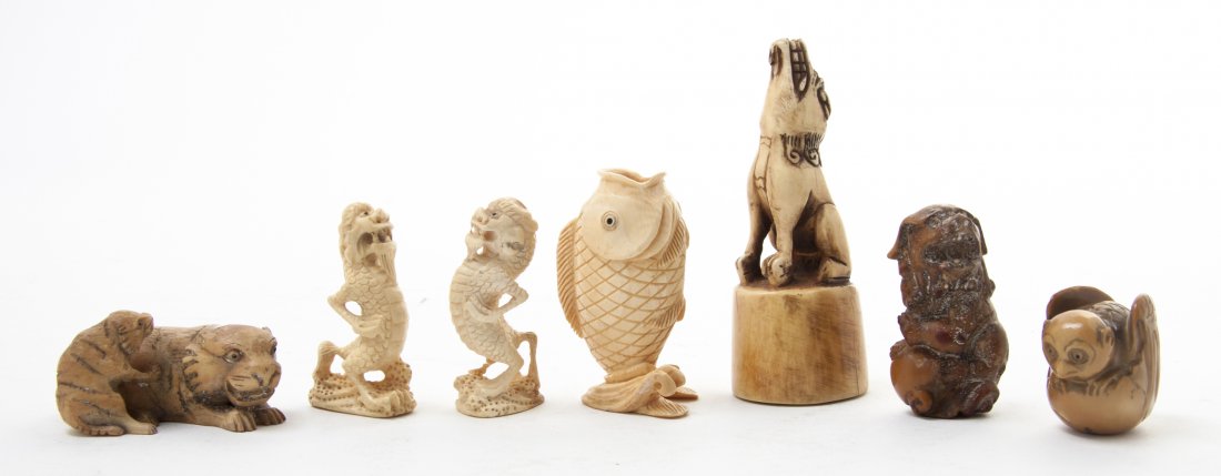 A Group of Seven Carved Ivory Articles, Height of: A Group of Seven Carved Ivory Articles, comprising a netsuke in the form of a recumbent tiger with a cub, a netsuke in the form of a dog with paw on a ball, a netsuke in the form of a dragon emerging 
