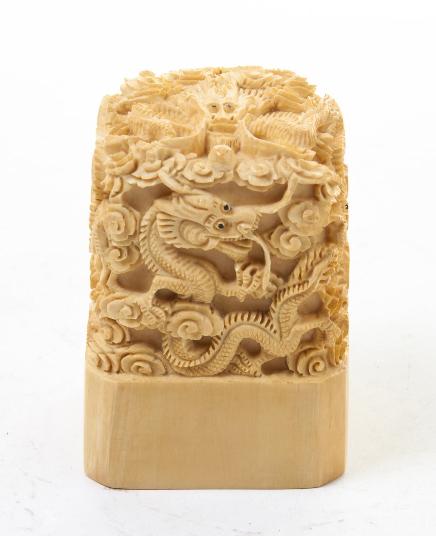 A Carved Ivory Seal Stamp, Height 3 1/4 inches.: A Carved Ivory Seal Stamp, depicting multiple writhing dragons amidst scrolling clouds. Height 3 1/4 inches. Property from the Collection of Albert and Ruth Katz, Chicago, Illinois