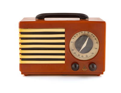 An Emerson Patriot Aristocrat 400 Radio: An Emerson Patriot Aristocrat 400 Radio Designed by Norman Bel Geddes, 1940 having a burnt orange case with brown handle, knobs and brown and white grille.Height 7 1/4 x length 10 7/8 x depth 5 3/8 in