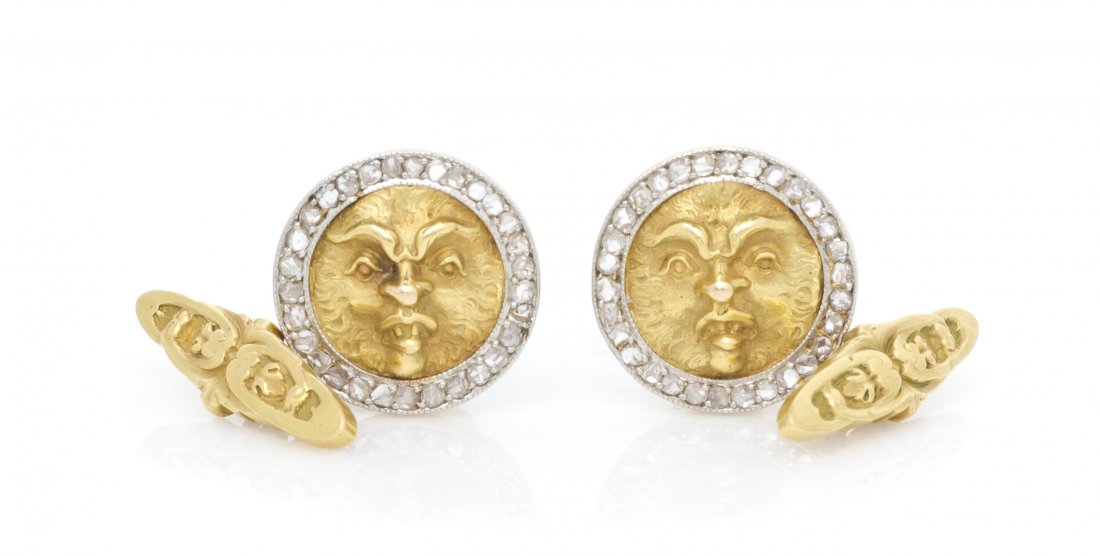 A Pair of Edwardian 18 Karat Gold and Diamond North: A Pair of Edwardian 18 Karat Gold and Diamond North Winds Cufflinks, consisting of a high relief face representing the North wind within a surround of numerous rose cut diamonds, joined by cable chain