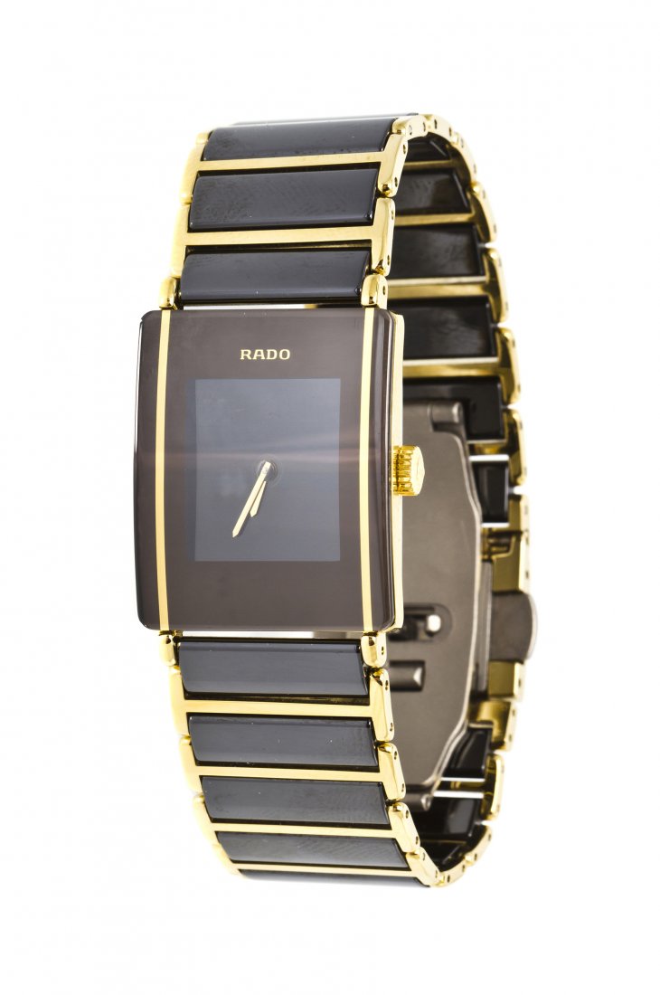 A Ceramic and Gold Tone DiaStar Wristwatch, Rado,: A Ceramic and Gold Tone DiaStar Wristwatch, Rado, matte grey black dial, gilt baton hands, rectangular case, Swiss quartz movement, rectangular link bracelet consisting of ceramic sections with gold t