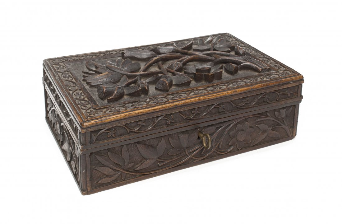A Continental Carved Oak Table Casket, Height 3 in: A Continental Carved Oak Table Casket, of rectangular form with a carved hinged lid, opening to two compartments, having floral and leaf decoration throughout. Height 3 inches.
