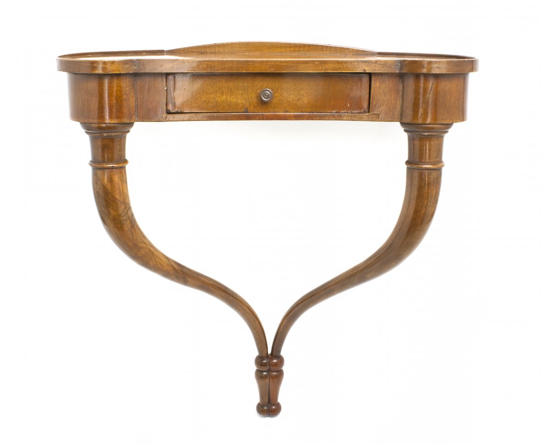A Continental Mahogany Wall Shelf, Height 22 1/4 x: A Continental Mahogany Wall Shelf, in the form of a diminutive console table, having a shaped top over a conforming frieze with a single drawer, raised on downswept conjoined legs. Height 22 1/4 x wid