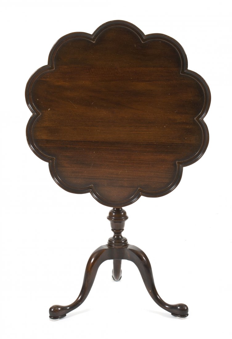 An American Mahogany Tilt-Top Tea Table, Height 28: An American Mahogany Tilt-Top Tea Table, having a scalloped circular dished top over a turned standard, set on a tripod base. Height 28 1/2 x diameter 26 1/4 inches.