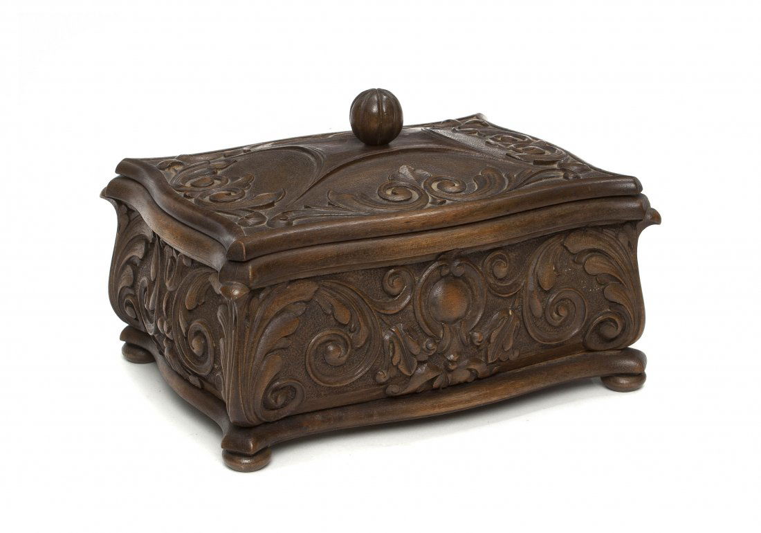 A Carved Walnut Box, Height 3 inches.: A Carved Walnut Box, of shaped rectangular form with a lobed ball finial, having scrolling acanthus leaf decoration throughout, raised on flattened feet. Height 3 inches.