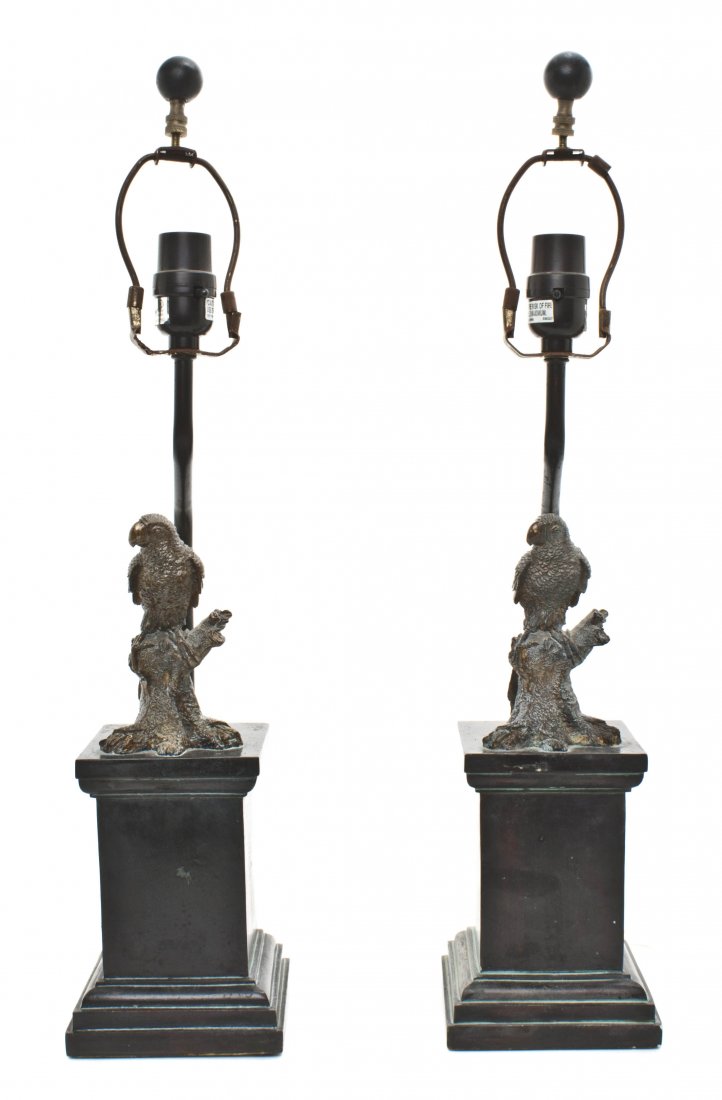 A Pair of Decorative Composite Animalier Lamps, He: A Pair of Decorative Composite Animalier Lamps, each having a parrot perched on a naturalistic base, further set on an elongated square plinth. Height 24 1/2 inches.